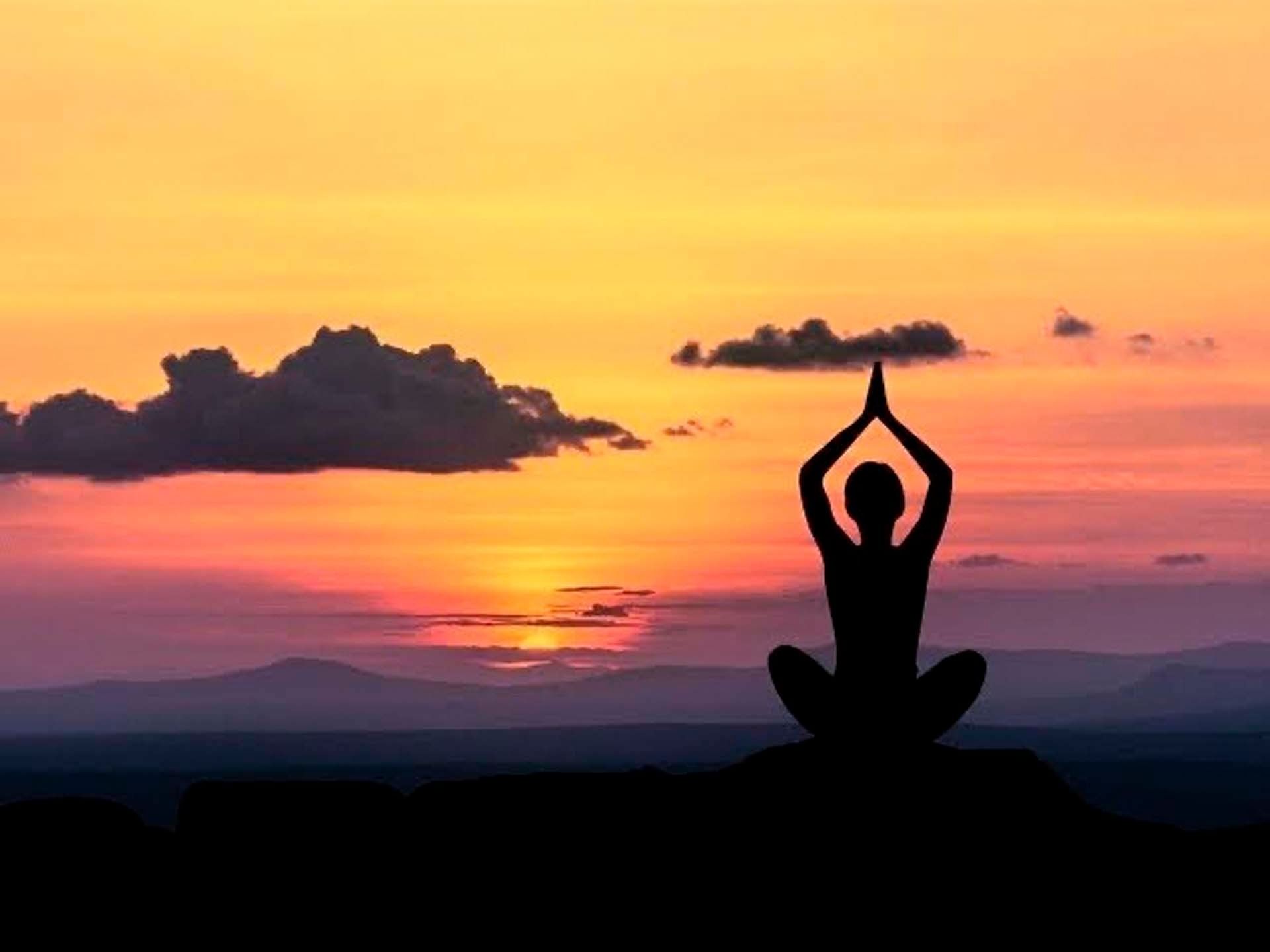 Woman doing yoga exercise at Paradox Phuket Resort