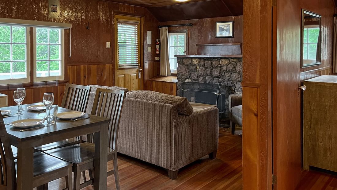Dining table, sofa and fireplace in cabin