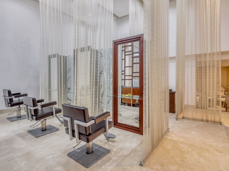 Salon chairs with mirrors in Gem Spa at Grand Fiesta Americana