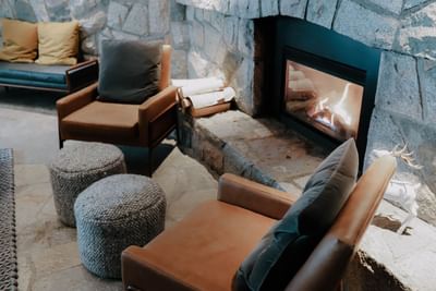 Rustic luxury hotel lobby with a fireplace at Adara Hotel