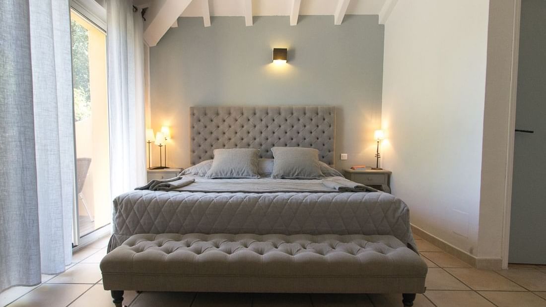 Comfy bed with side tables in Privilege Double Room at Roc e Fiori