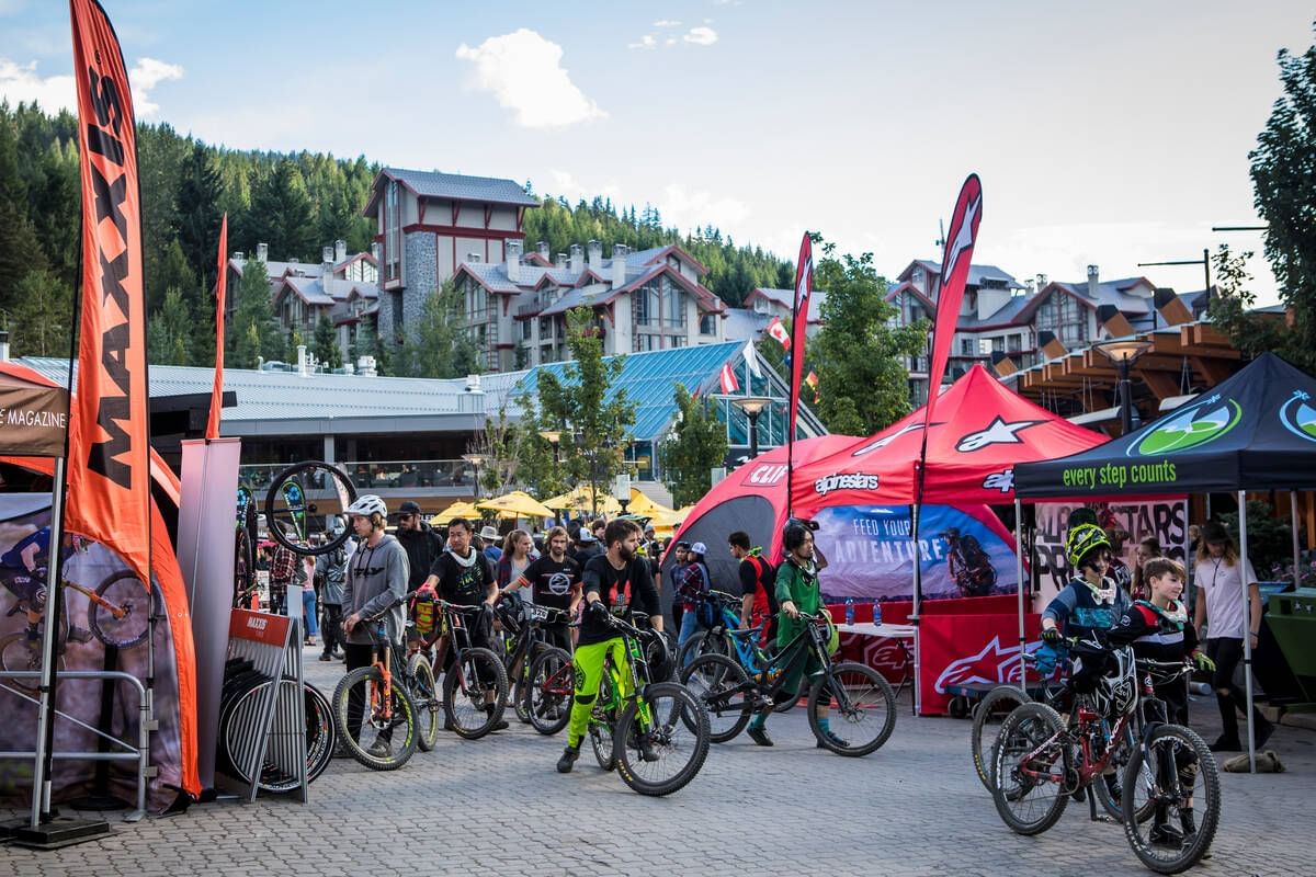 Bikers by stalls in an event near Blackcomb Springs Suites