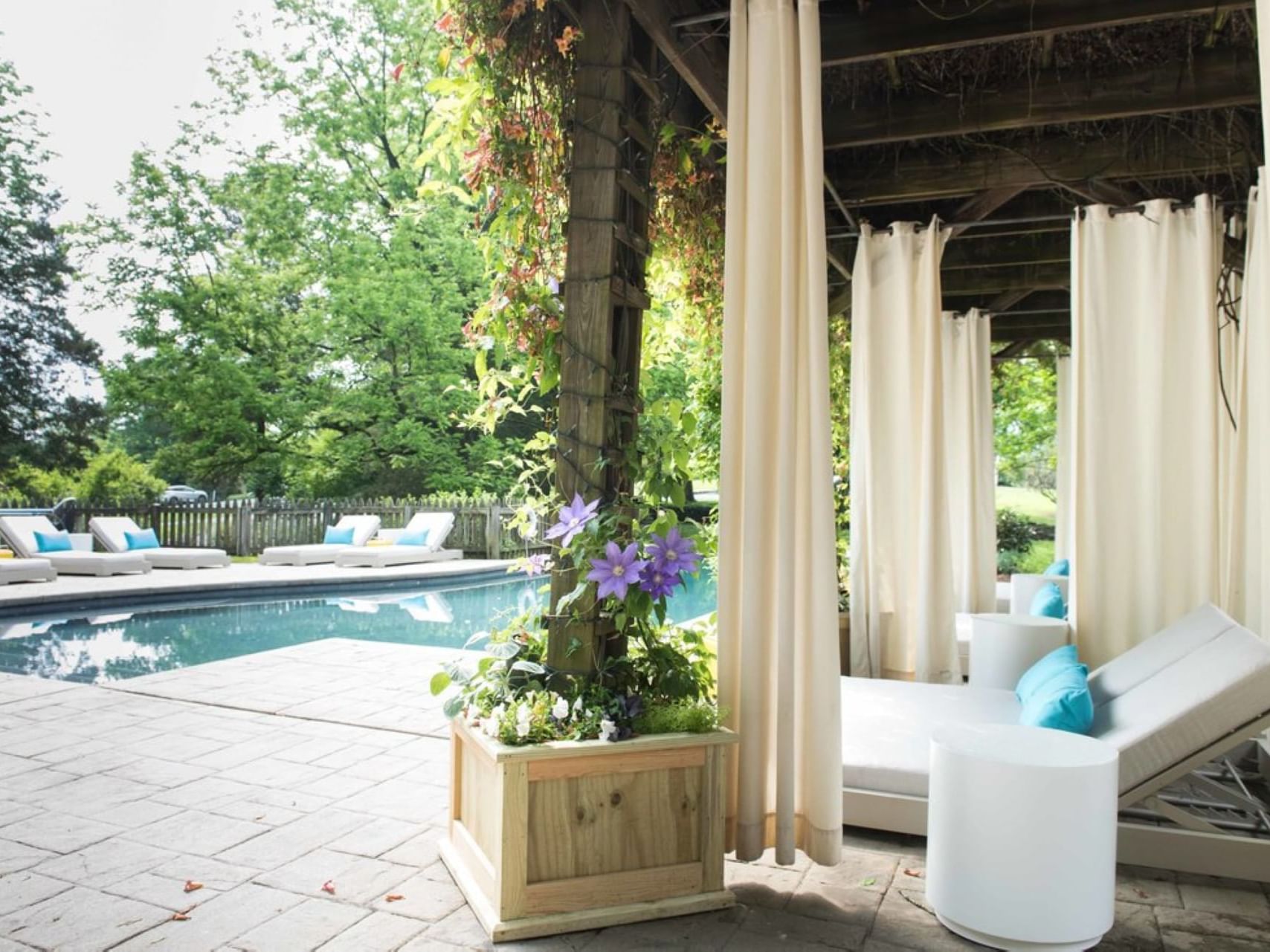 Cozy spa beds with covered patio & outdoor pool at The Clifton