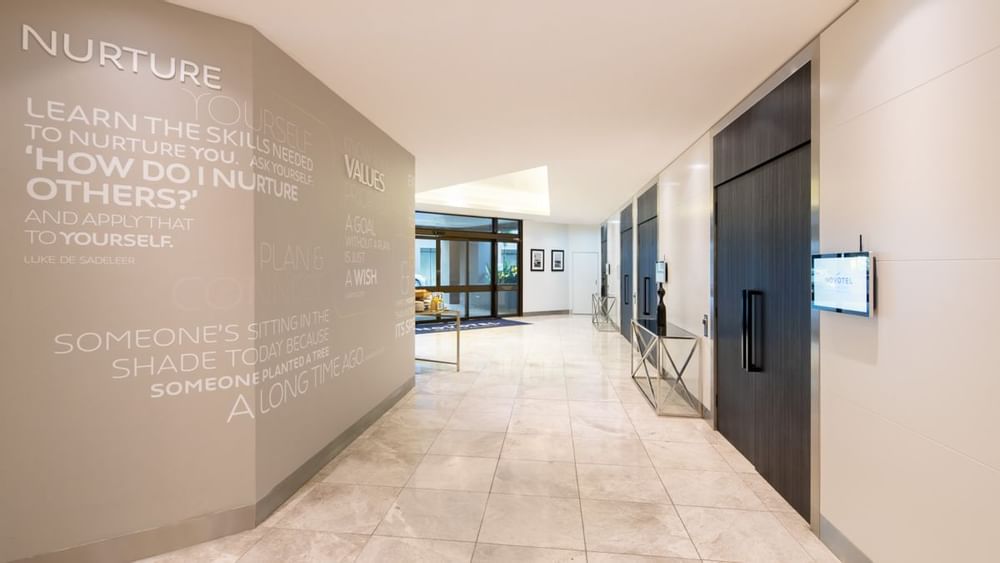 Grand Ballroom hallway with wall art and entrances to meeting rooms at Novotel Sydney International Airport