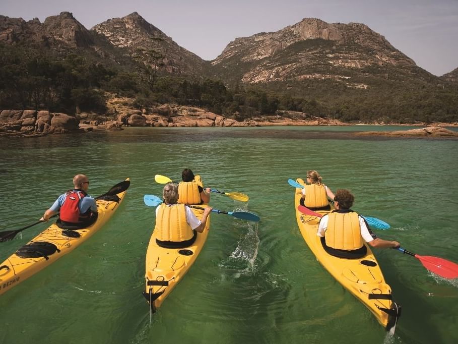 People on kayaking at the bay near Freycinet Lodge