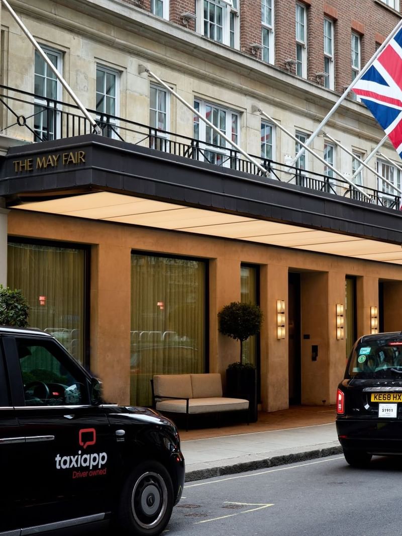 Taxis parked outside the entrance of The May Fair Hotel in London.