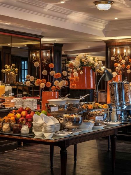 Buffet breakfast table with fresh fruits, pastries, and coffee at Warwick Grand-Place Brussels