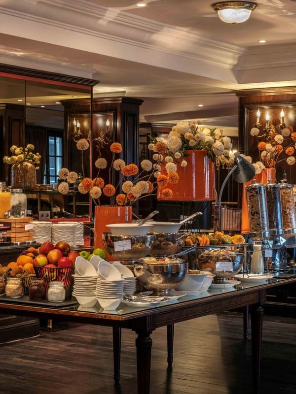 Buffet breakfast table with fresh fruits, pastries, and coffee at Warwick Grand-Place Brussels