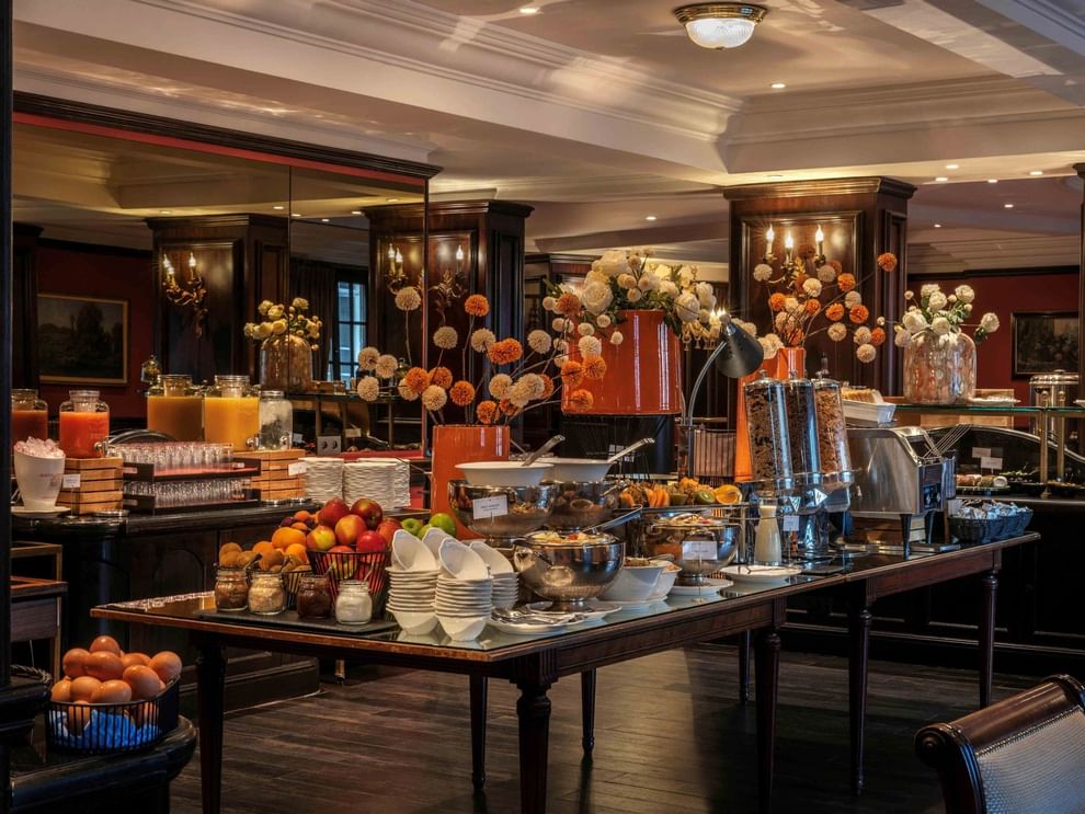 Buffet breakfast table with fresh fruits, pastries, and coffee at Warwick Grand-Place Brussels