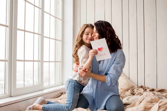 Mother hugging cute daughter with card at Danna Langkawi Hotel