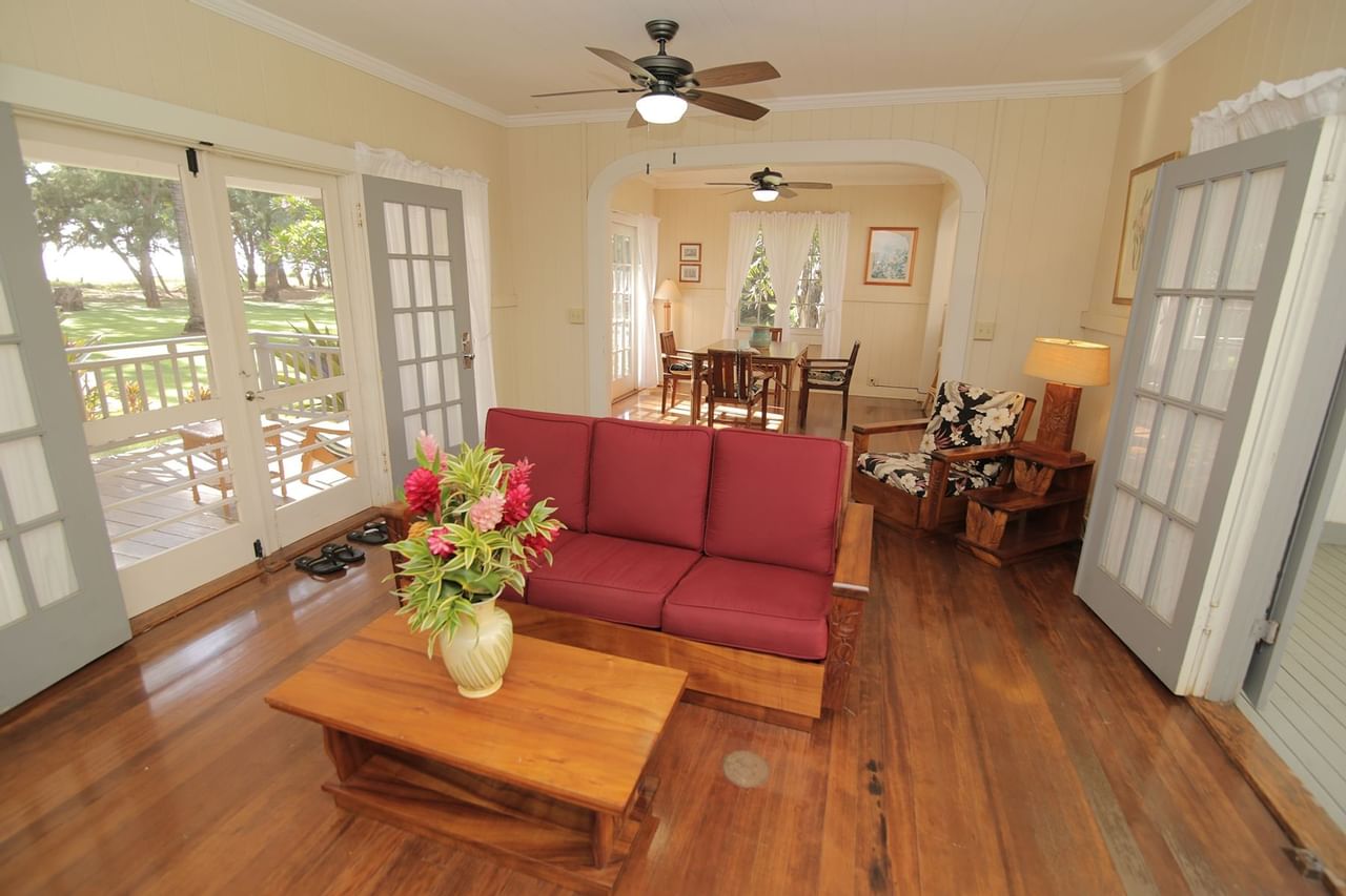 Living room with patio doors to private balcony at Waimea Plantation Cottages