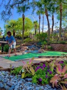 Child playing miniature golf at Pirate's Cove Adventure Golf in Orlando
