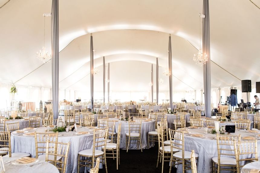 a ballroom with round tables and chairs