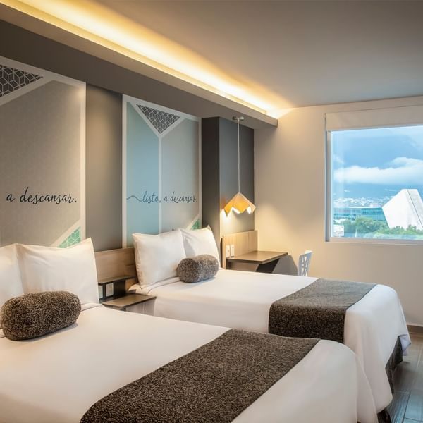 Twin beds in One Plus 2 Twin with a city view at One Hotels