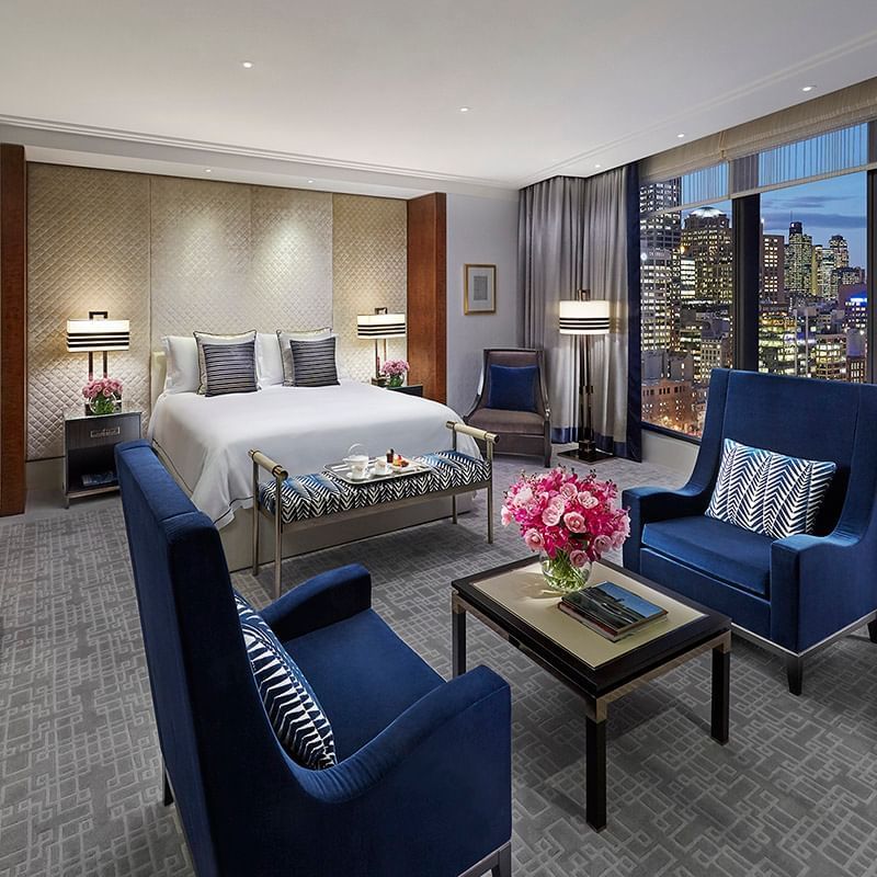 Deluxe Villa with a bed & sofa chairs at Crown Hotel Melbourne