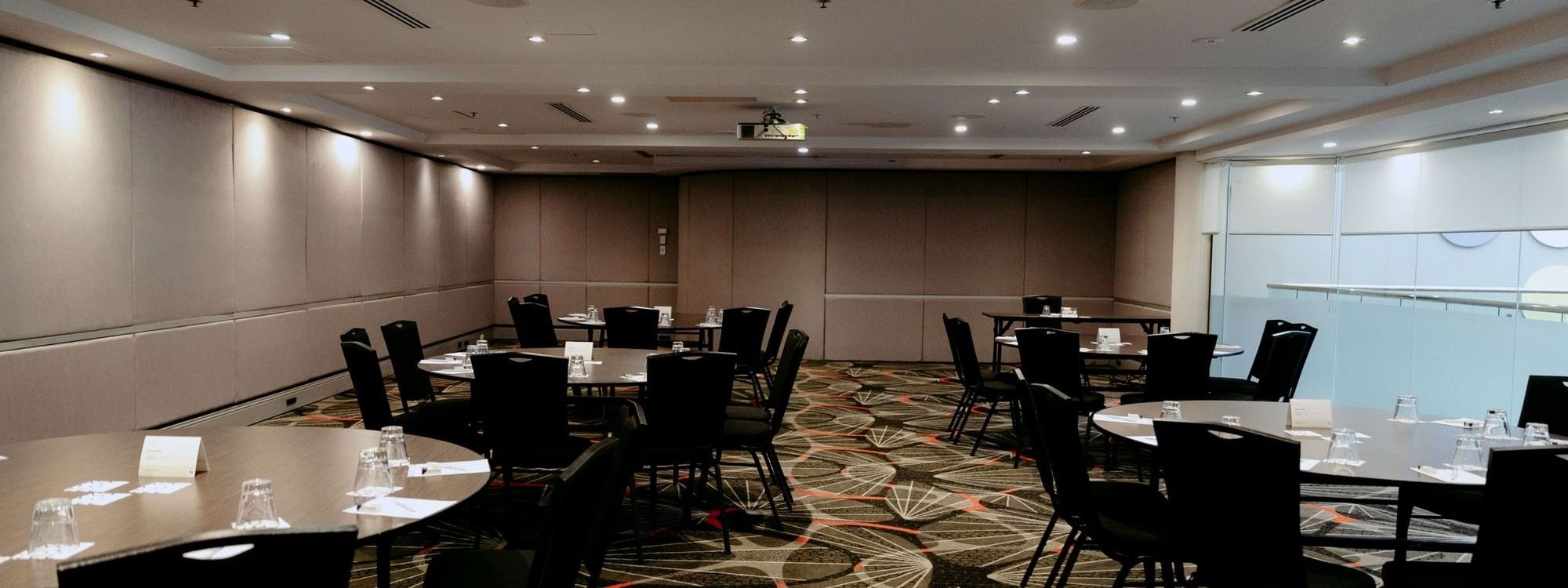 Linden Room event space with round tables and chairs at Novotel Sydney Parramatta.