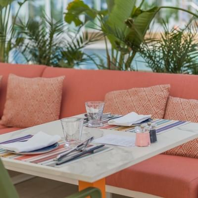 Couch & dining table at HOKU Restaurant, Falkensteiner Hotels