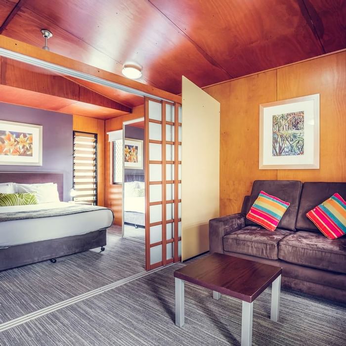 Living area & king bed in a room at Darwin Airport Hotels