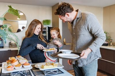 Happy family enjoying breakfast buffet together at Rodd Royalty, one of the best places to stay in Charlottetown, PEI