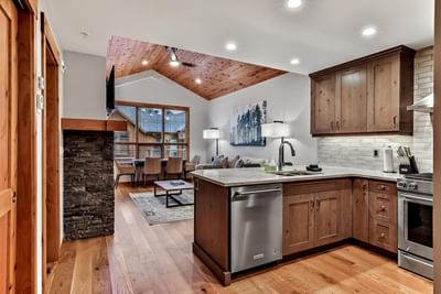 Modern kitchen interior with living area in 409 White Spruce Lodge One Bedroom Elevated Condo at Spring Creek Vacations