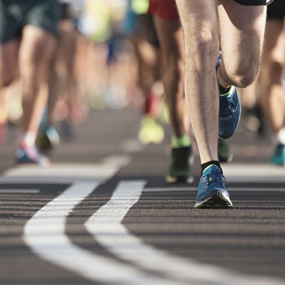Close-up of people running a marathon near Waikiki Resort Hotel by Sono