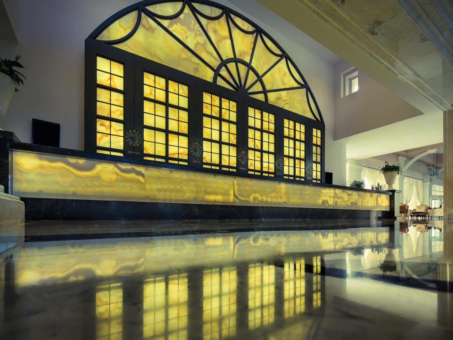 Lobby with a backlit marble reception desk at Titanic Deluxe Golf Belek