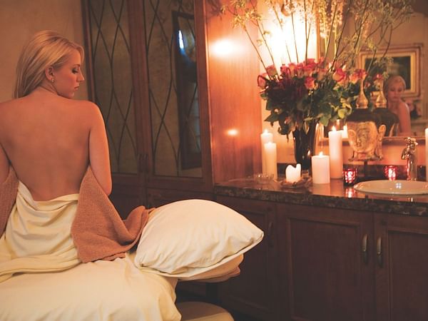 A woman on a massage table at the Spa in Kelly's Spa & Boutique