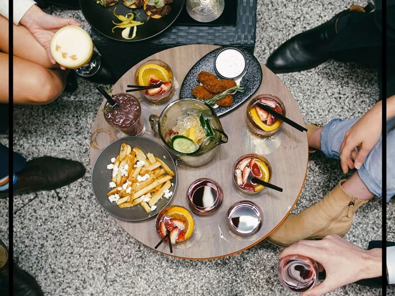 Variety of food dishes served on a table in Sixteen Antlers Rooftop Bar at Pullman & Mercure Brisbane King George Square