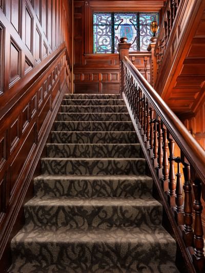 Wooden finished staircase in the lobby at Pendray Inn & Tea House