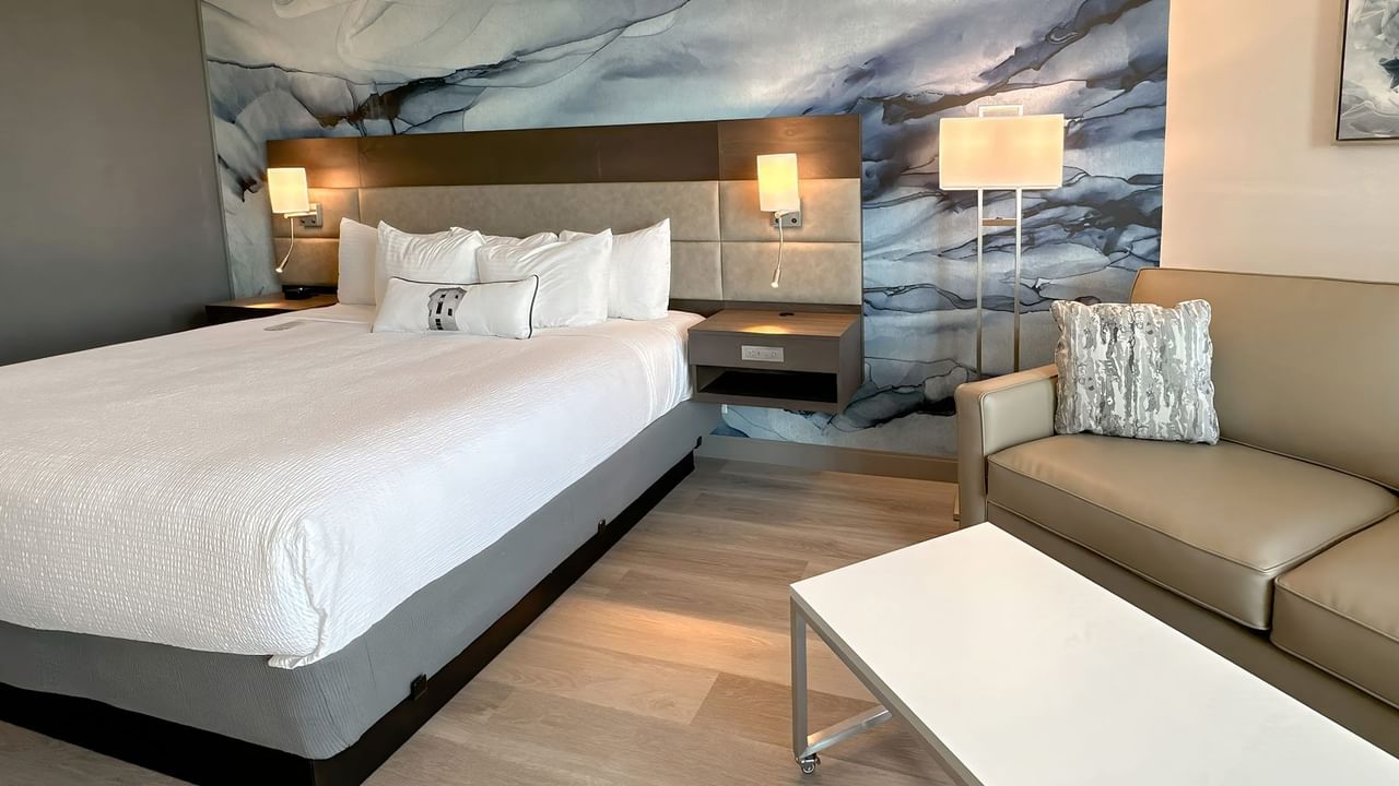 Hotel guestroom with King bed and a blue wall mural