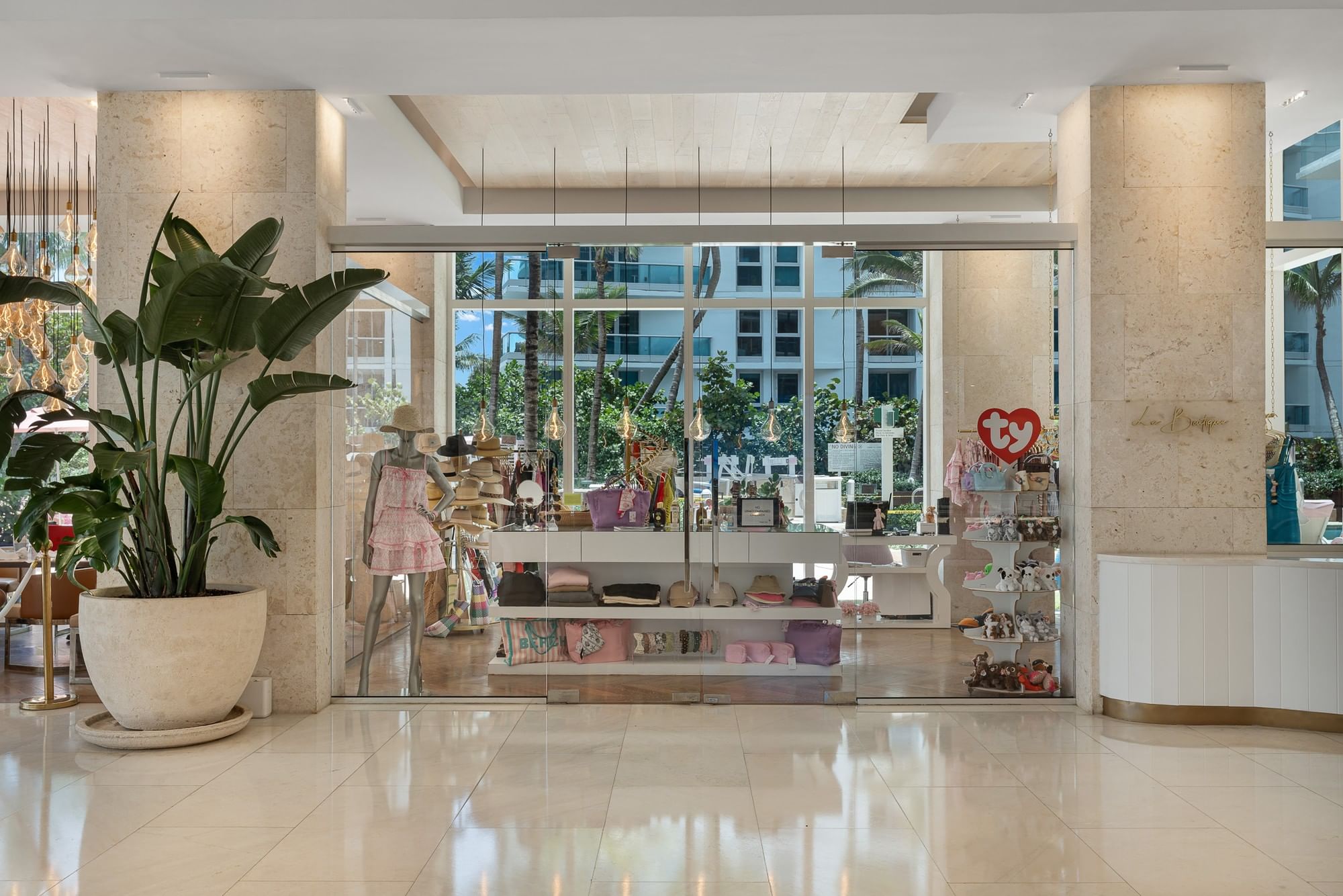 A gift shop with a large window display and a mannequin inside.