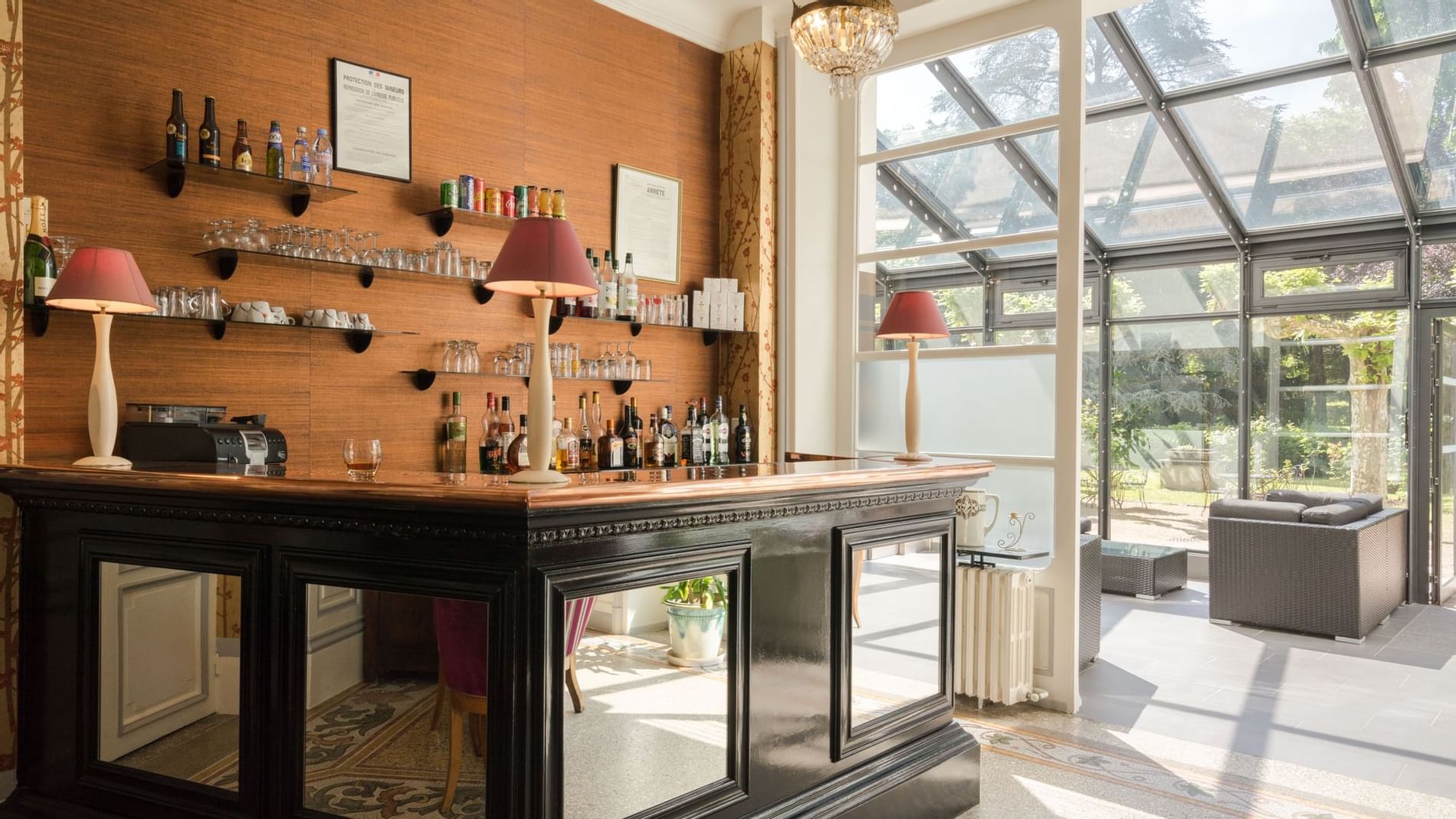 Bar area with bottles & glasses at The Originals Hotels