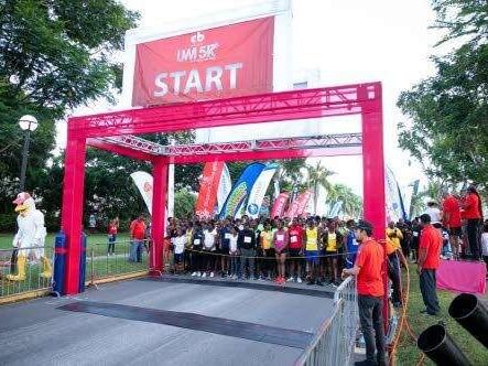 Runners lined up at the start arch for the CB Group UWI 5K race near Jamaica Pegasus Hotel