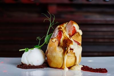 Postre gourmet con masa rellena de queso derretido, servido con helado y crumble de chocolate en el Sunset Plaza Beach Resort, uno de los mejores hoteles con vistas a la playa en Puerto Vallarta