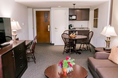 living room suite with table, chairs, television and sofa