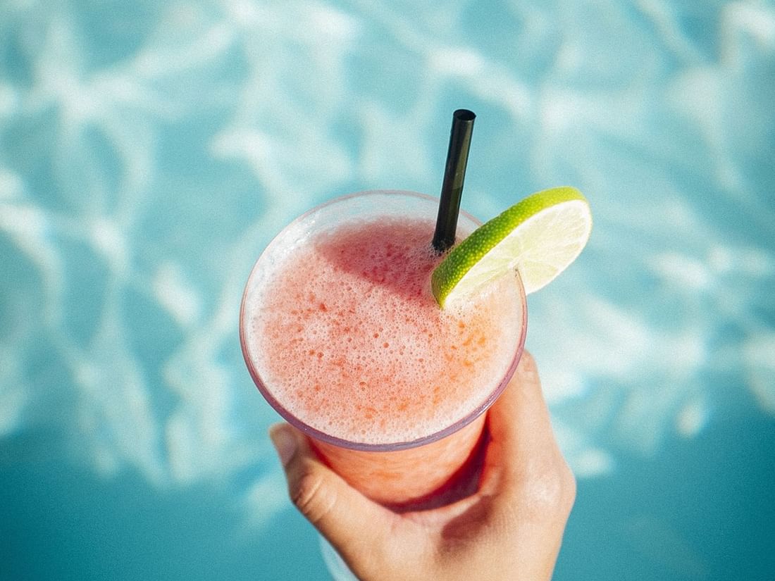 A cocktail served by the pool at Warwick Melrose Dallas