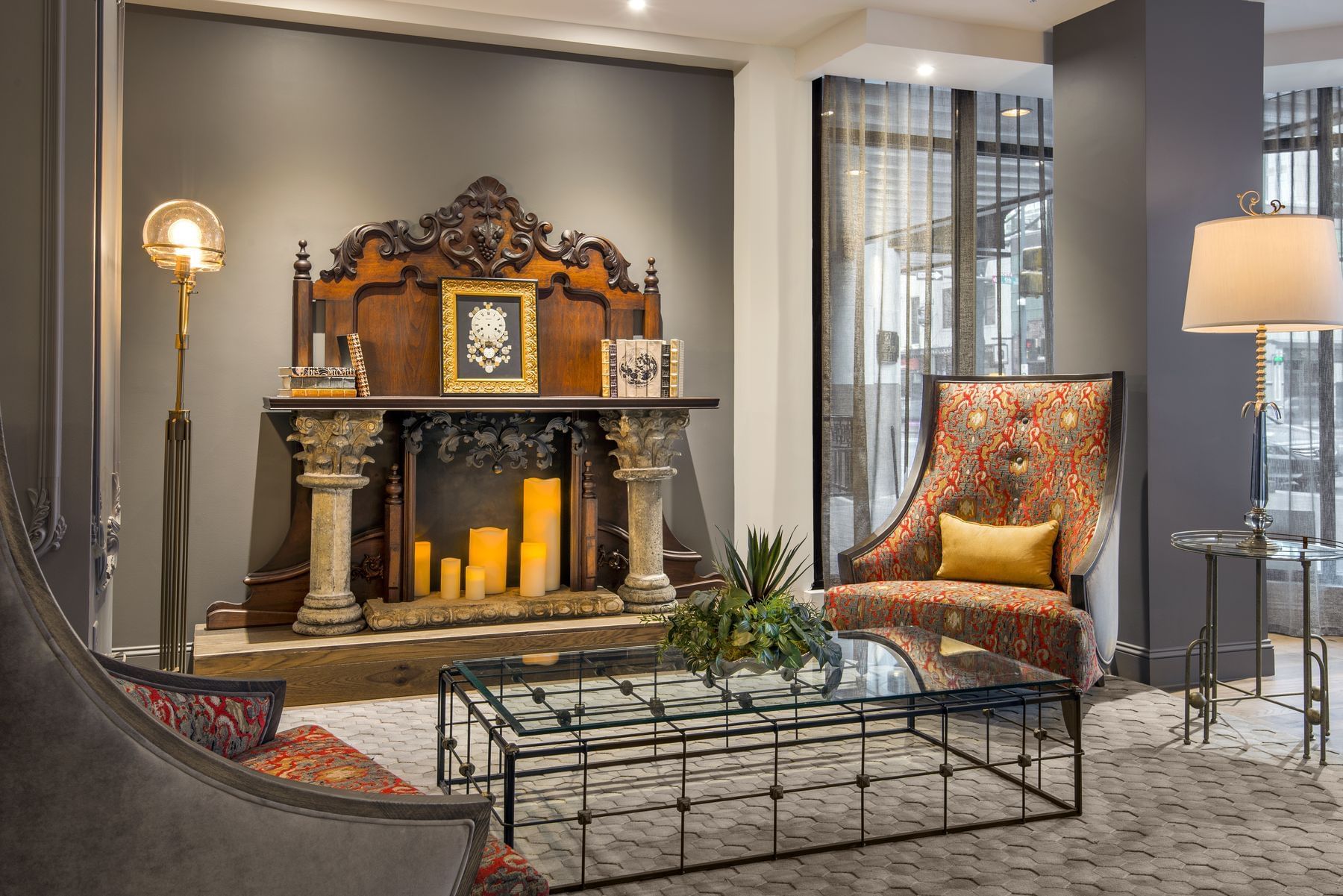 A cozy seating area with a fireplace, chair, and coffee table in a hotel lobby.