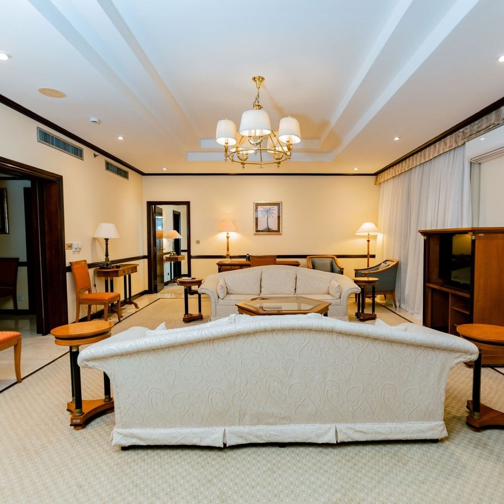 Elegantly furnished Presidential Suite with chandelier and cushioned furniture at Dar Es Salaam Serena Hotel.