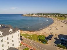 Aerial view of Short Sands Beach with sunbathers near Union Bluff Hotel