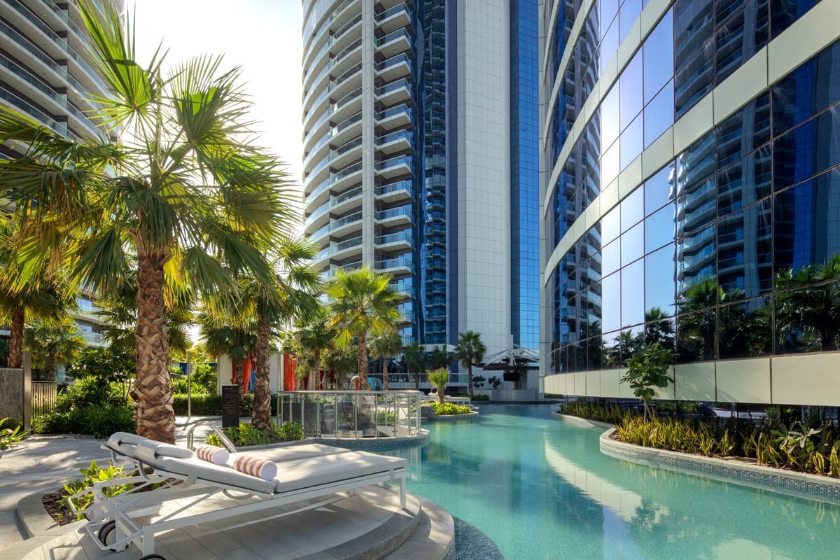 Exterior view of Paramount Hotel Dubai with outdoor pool and sun lounges