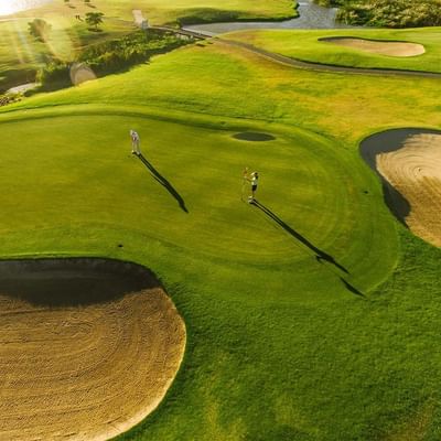 Two golfers playing on a golf course near Falkensteiner Hotels