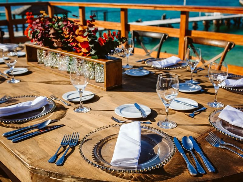 Dining table arranged outdoors with an ocean view at Grand Fiesta Americana Hotel and Resorts