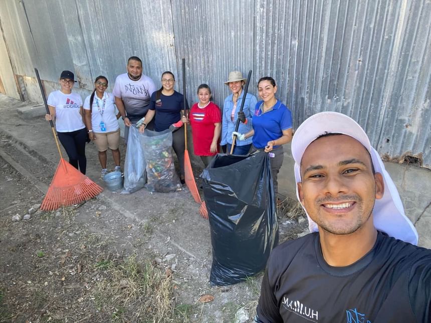 A group of volunteers clean near Fiesta Resort