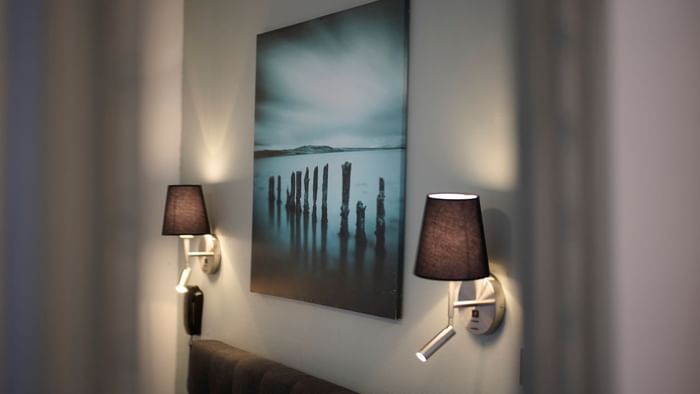 Night lamps & wall art in a room at The Originals Hotels