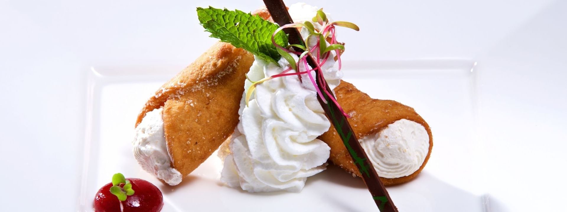 Crispy cannoli with whipped cream under a chocolate garnish in Abbiocco at Warwick Paradise Island Bahamas