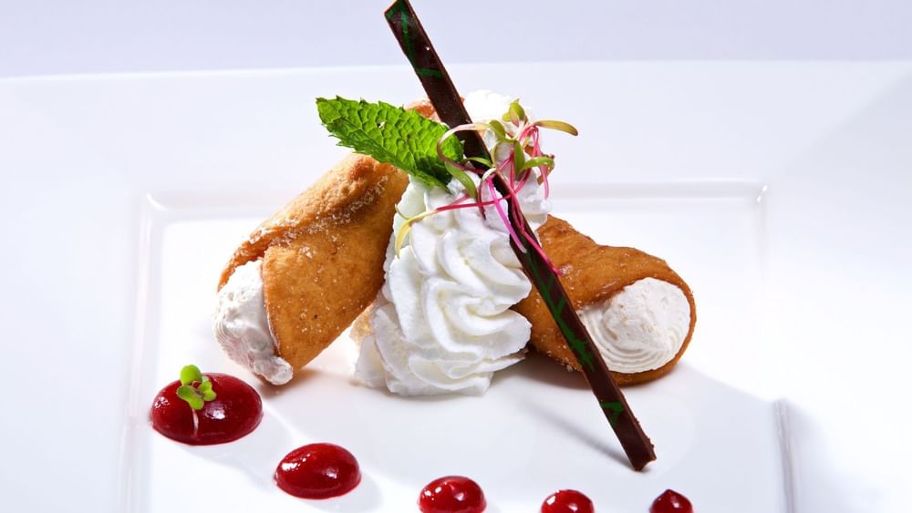 Crispy cannoli with whipped cream under a chocolate garnish in Abbiocco at Warwick Paradise Island Bahamas