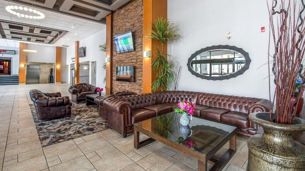 Hotel lobby with couches, table, and decorative items.
