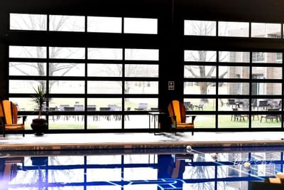 large clear doors surround an indoor pool