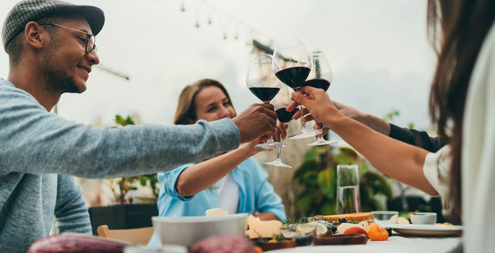 Group of friends cheers with wine