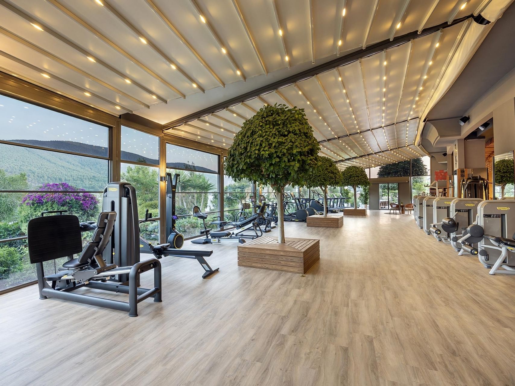 The gym at Titanic Luxury Collection Bodrum blends light and wood in perfect harmony.